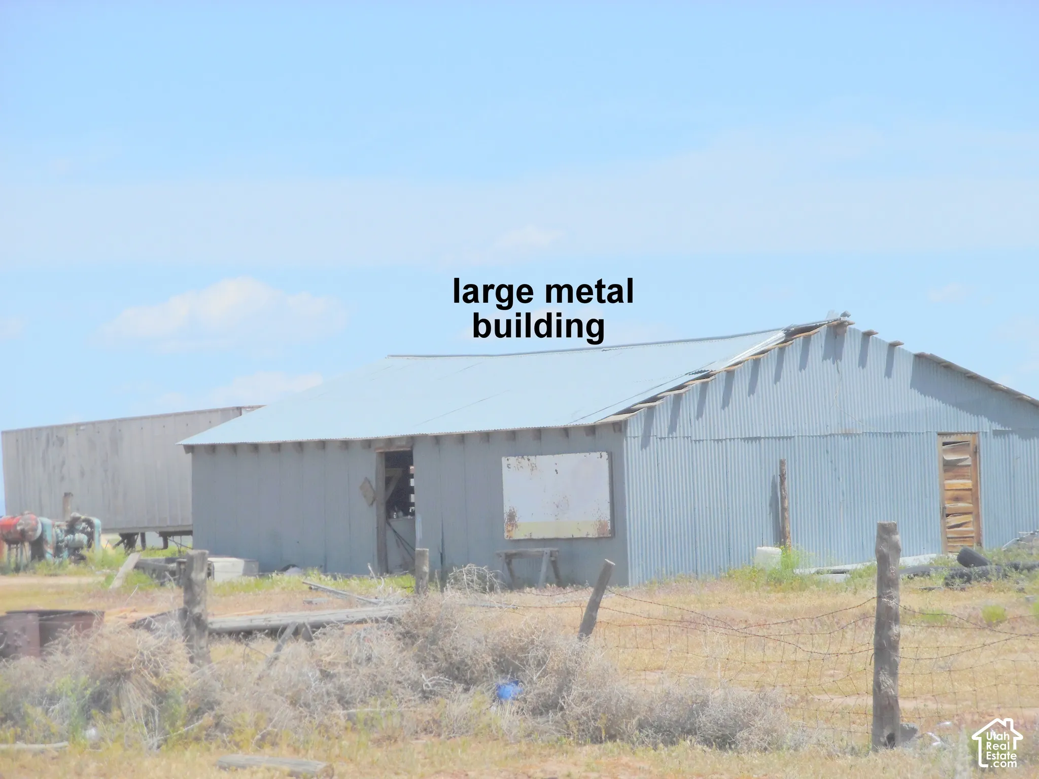 Large metal outbuilding featuring corrugated metal siding and a pitched metal roof