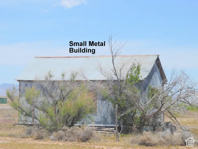 Detached metal structure featuring a gable roof and corrugated metal siding