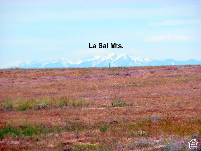 Expansive lot featuring native terrain and prominent mountain range backdrop