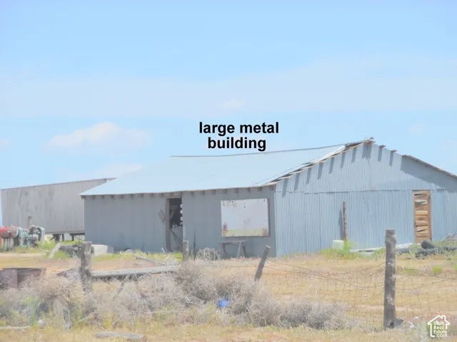 Large metal outbuilding featuring corrugated metal siding and a pitched metal roof