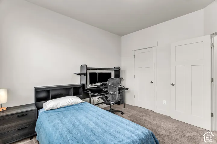 Neutral interior space featuring carpeted flooring, neutral wall paint, and two-panel interior doors
