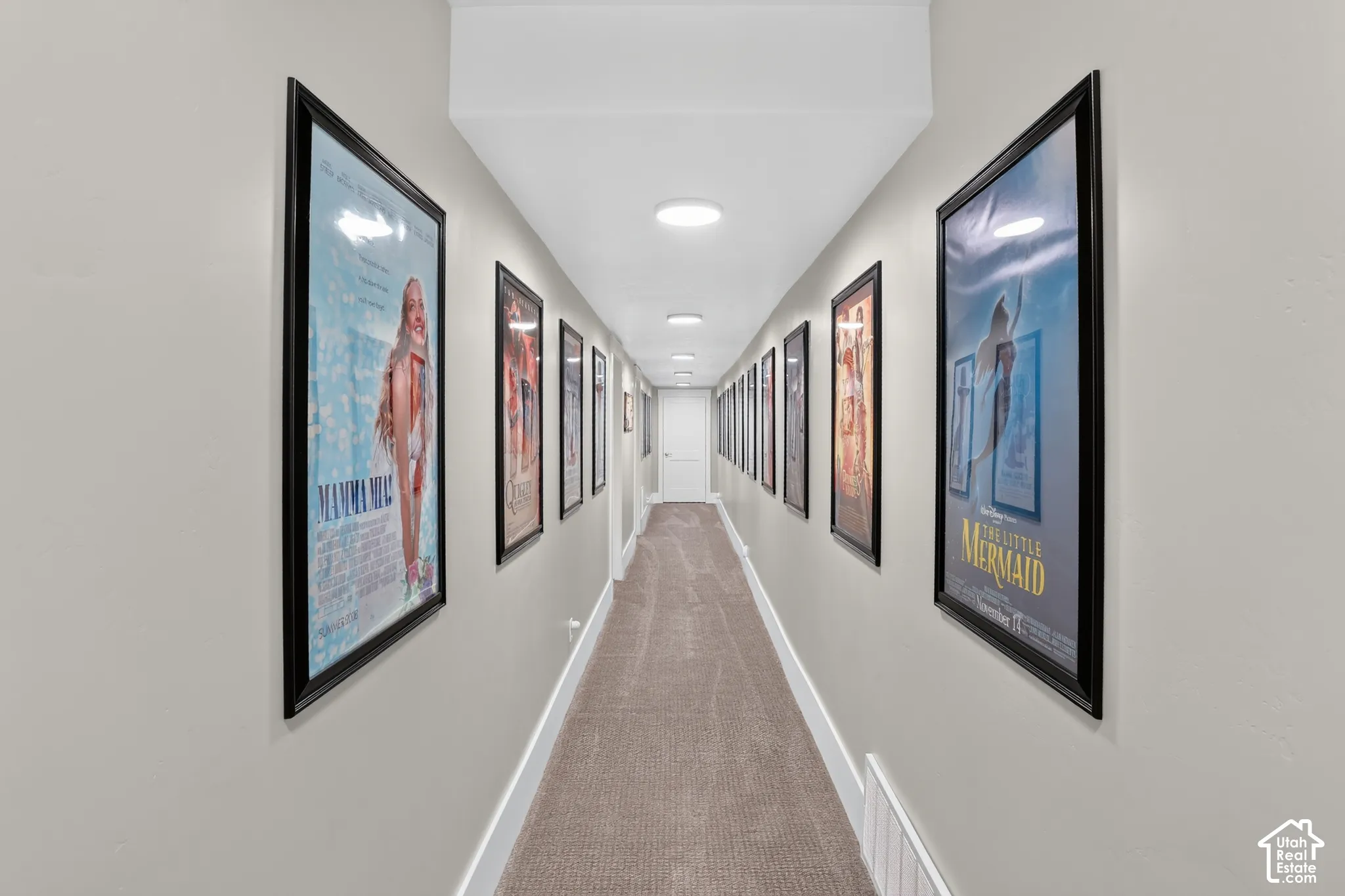 Neutral wall-toned hallway featuring recessed ceiling lighting and wall-to-wall carpeting