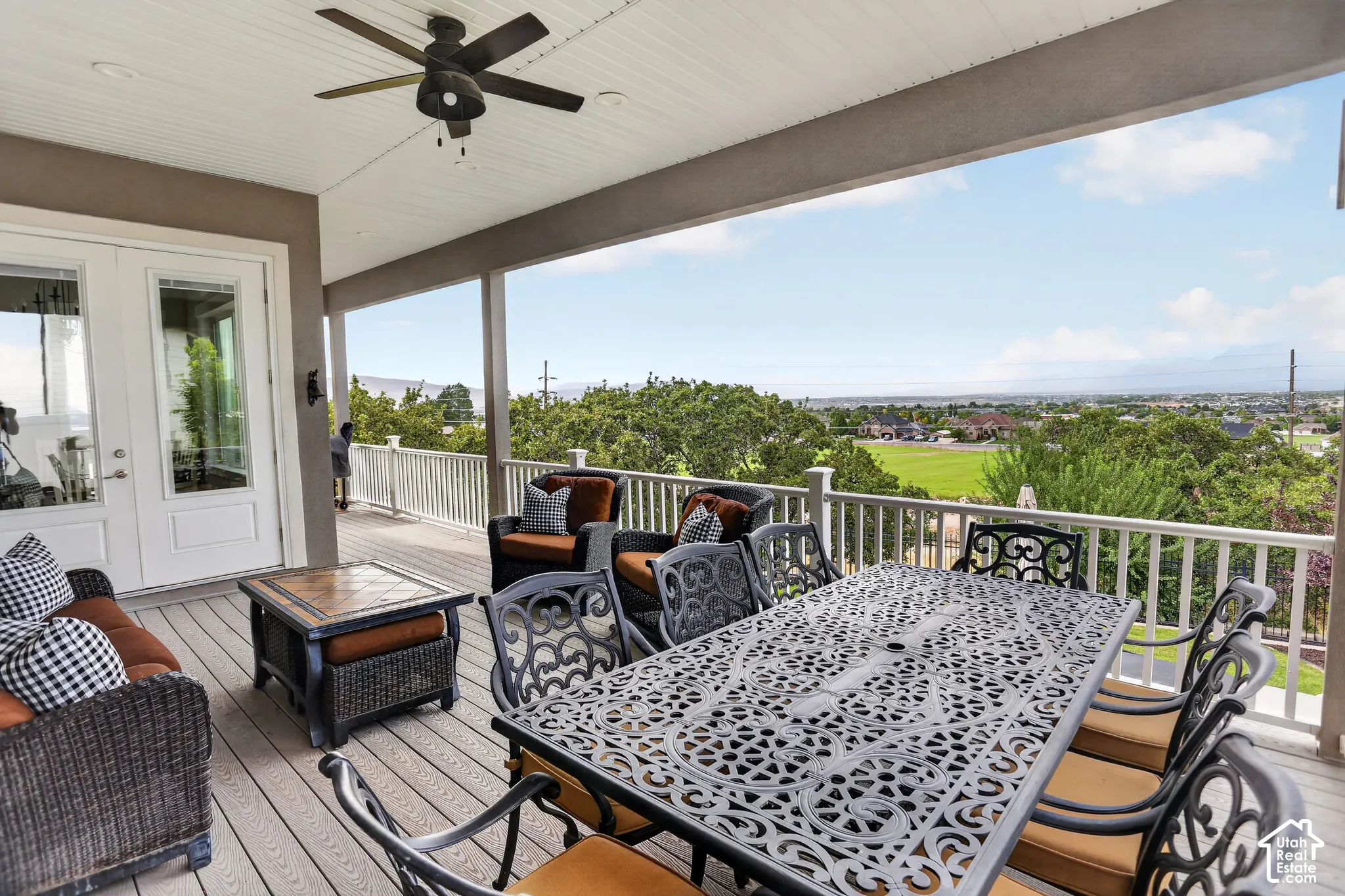 Covered deck featuring composite decking, white railing, recessed ceiling lighting, and a ceiling fan