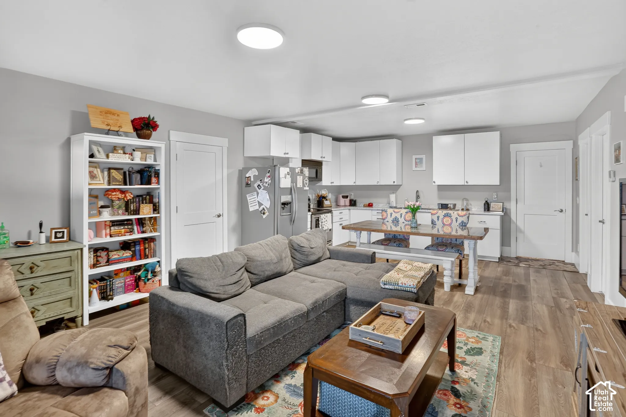 Kitchen featuring white cabinetry, wood-finish flooring, and recessed ceiling lighting