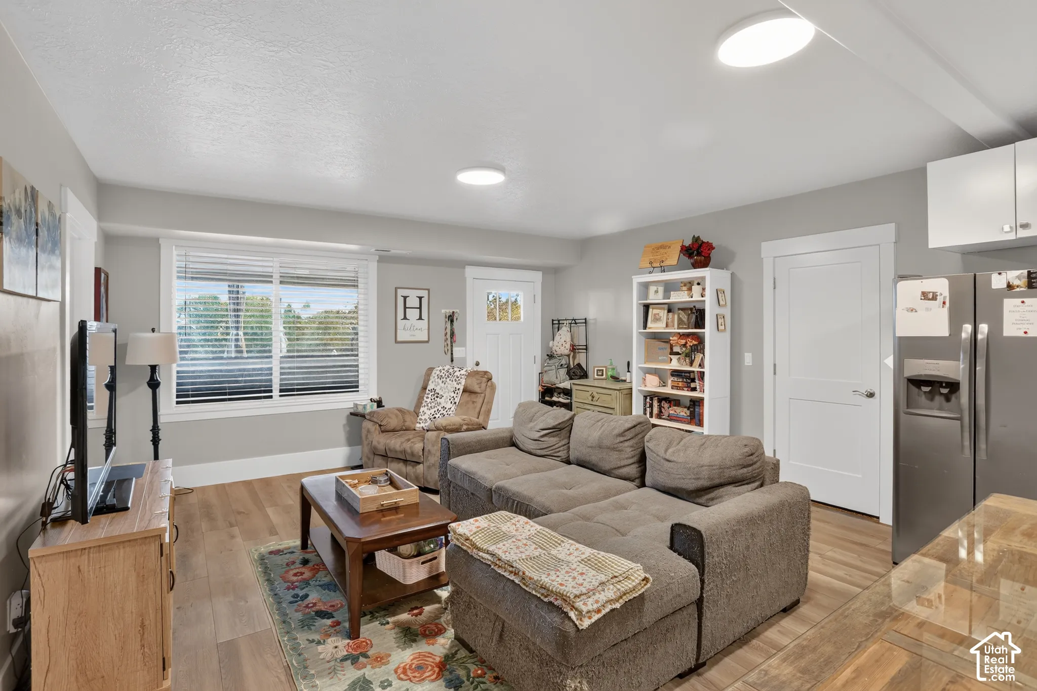 Interior space featuring wood-finish flooring, recessed LED lighting, and a multi-pane window