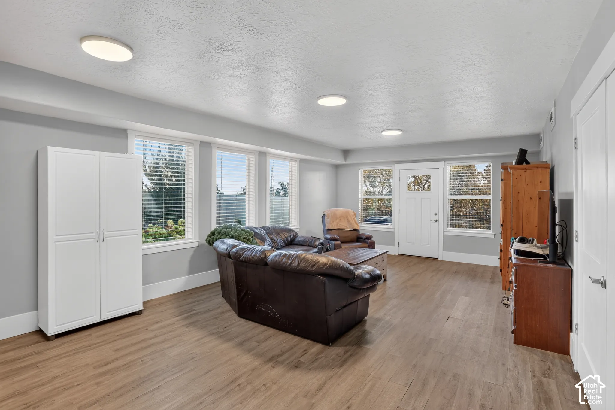 Interior space featuring wood-finish flooring, recessed lighting, and multiple windows