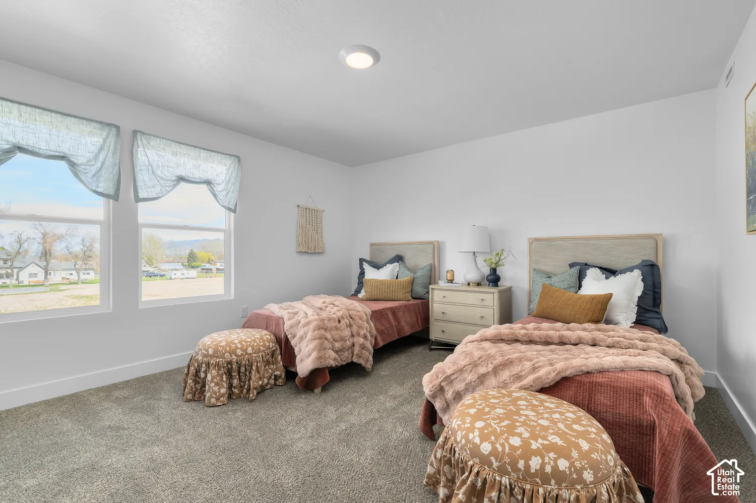 Neutral interior featuring wall-to-wall carpeting, high-efficiency recessed ceiling lighting, and dual windows providing natural illumination