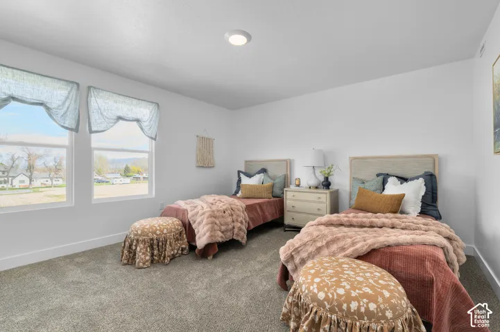 Neutral interior featuring wall-to-wall carpeting, high-efficiency recessed ceiling lighting, and dual windows providing natural illumination
