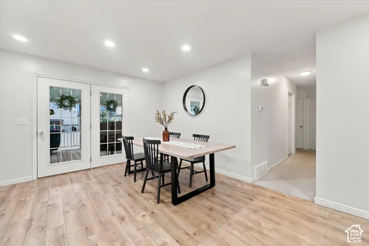 Neutral interior space featuring wood-finish flooring, recessed lighting, and double glass-pane doors