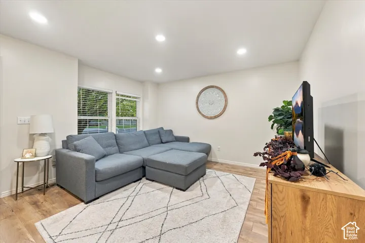 Living area featuring wood-finish flooring, recessed lighting, and dual pane windows