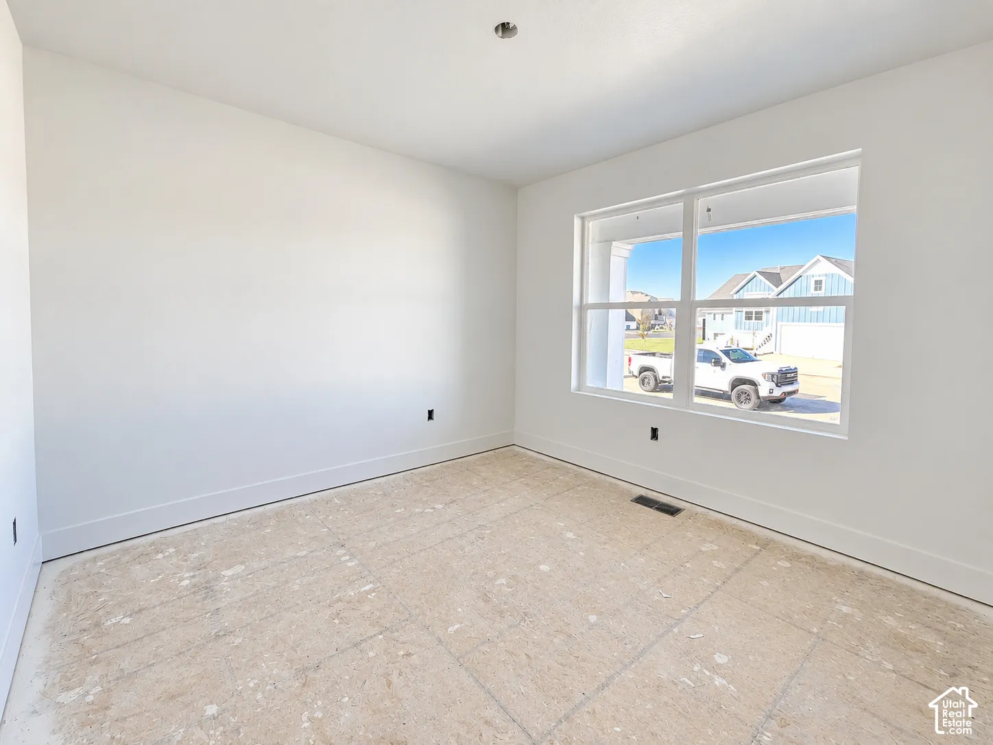 Neutral-toned walls with high-contrast window casing and expansive dual-pane windows
