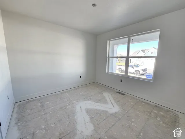 Neutral wall finishes, expansive dual-pane windows, and high ceiling with recessed lighting