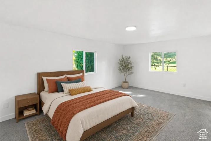 Neutral interior featuring wall-to-wall carpeting, white walls, and dual-pane sliding windows