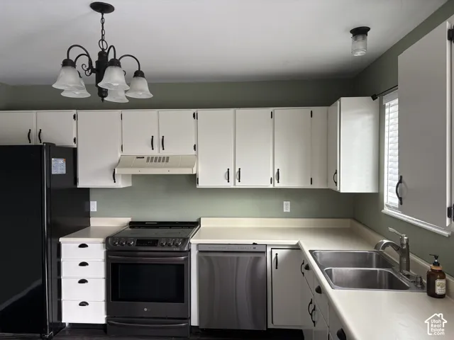 Kitchen featuring white shaker-style cabinetry with matte black hardware, stainless steel dishwasher, integrated range, and dual-basin stainless steel sink with a goose-neck faucet