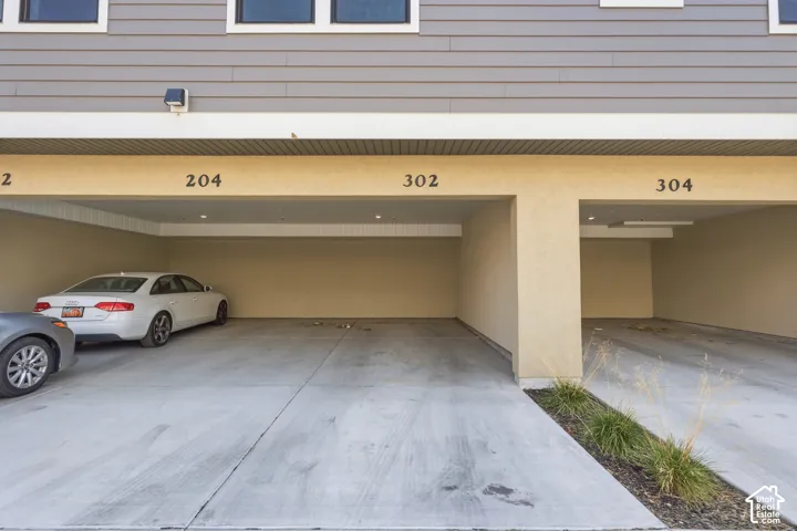 Covered carport featuring a concrete floor, recessed lighting, and horizontal siding exterior
