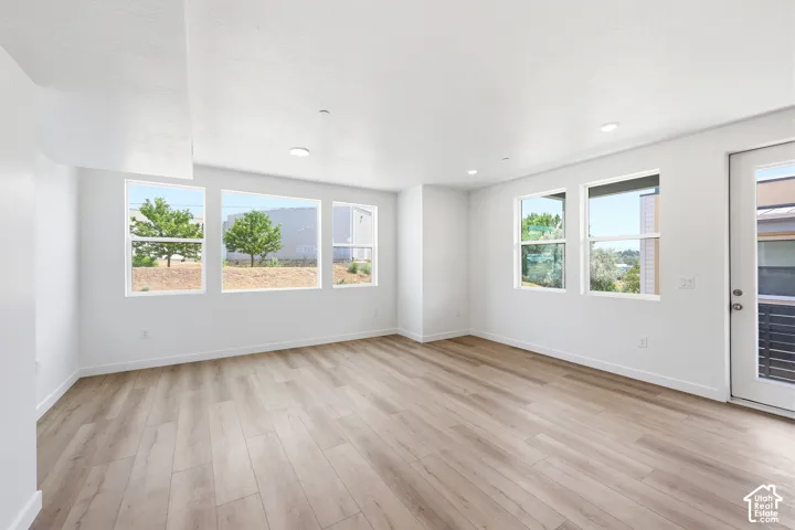 Interior space featuring wood-finish flooring, recessed lighting, and expansive windows