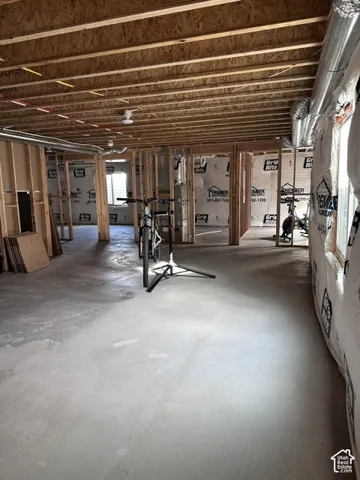 Unfinished lower level featuring exposed wood joist ceilings, concrete flooring, and perimeter wood-frame stud walls