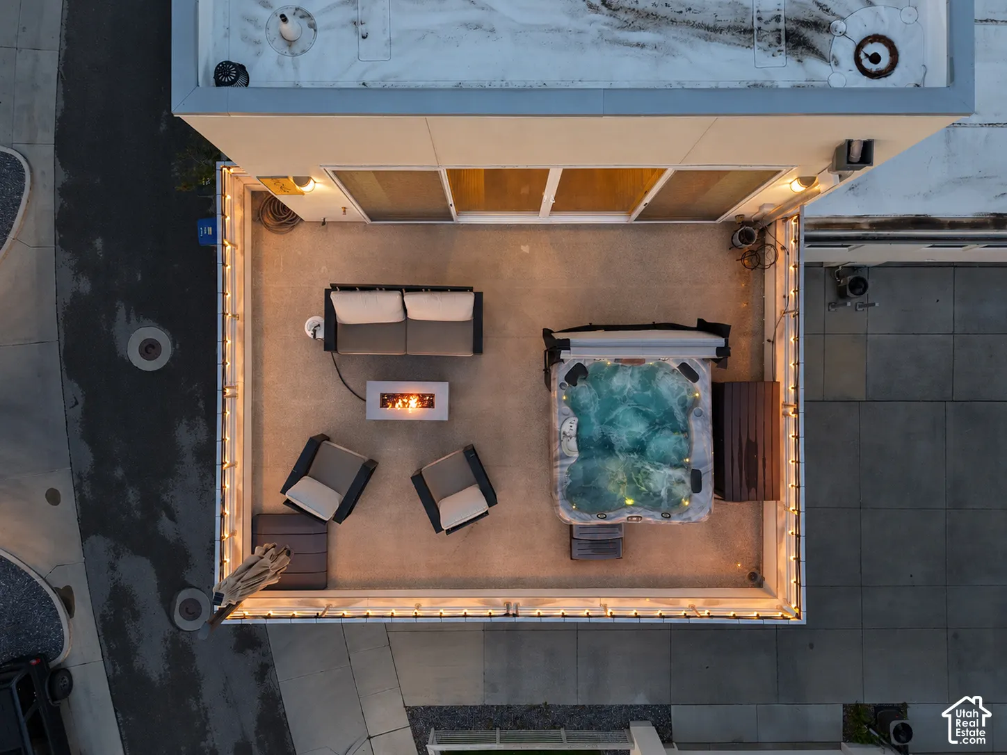 Rooftop terrace featuring concrete flooring, integrated spa, built-in fire feature, and perimeter railing