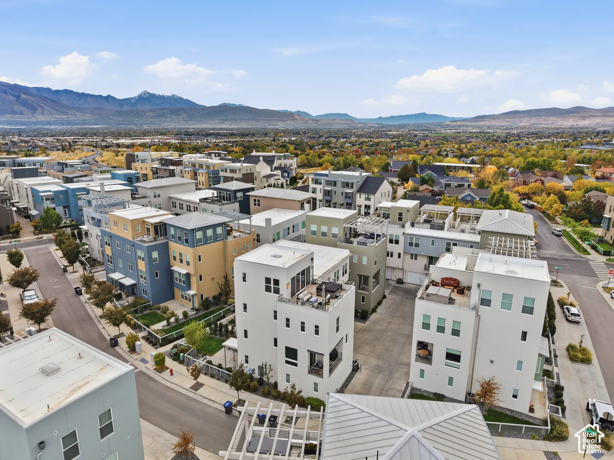 Aerial perspective of contemporary multi-story residences featuring flat rooflines, roof decks, and mountain scenery