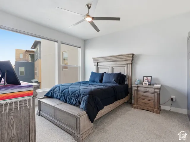 Neutral wall tones, carpeted flooring, and a contemporary ceiling fan with integrated lighting