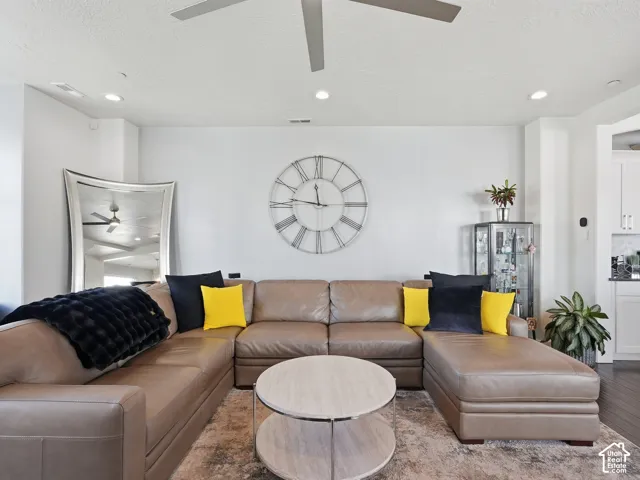 Neutral-toned interior featuring recessed lighting, a modern ceiling fan, and dark wood-finish flooring