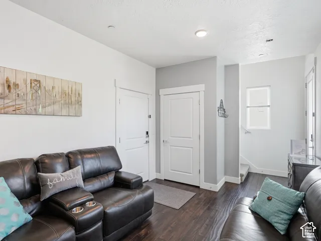Entry area featuring dark wood-finish flooring, two-panel interior doors with clean-lined trim, and recessed lighting