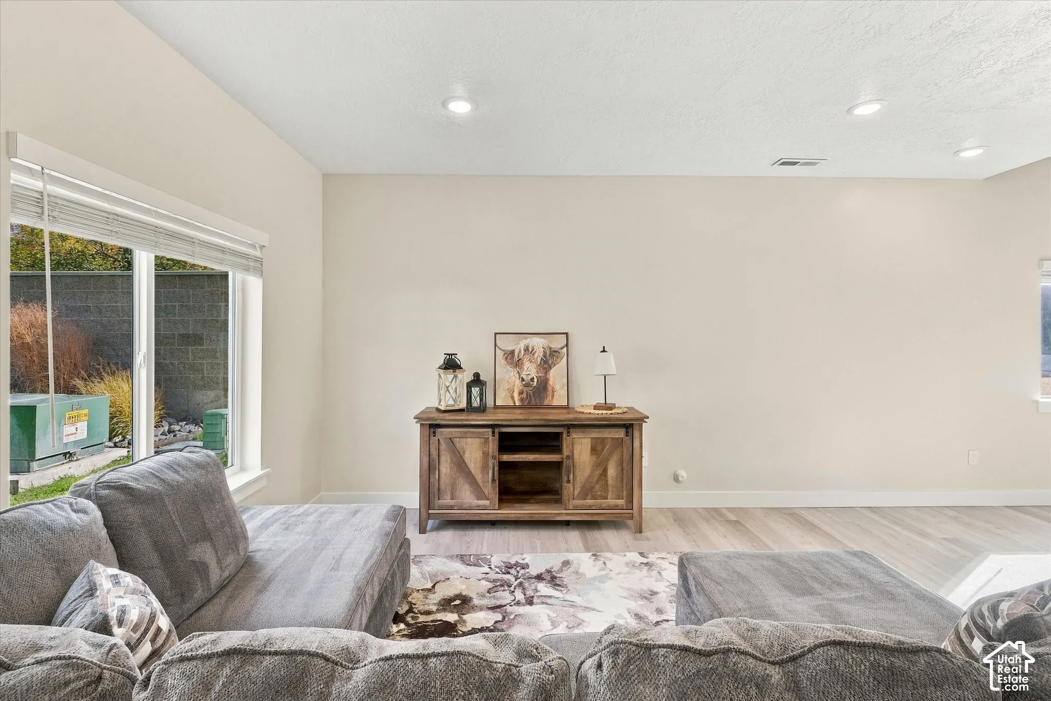 Interior featuring light-toned wood-finish flooring, recessed lighting, and expansive windows