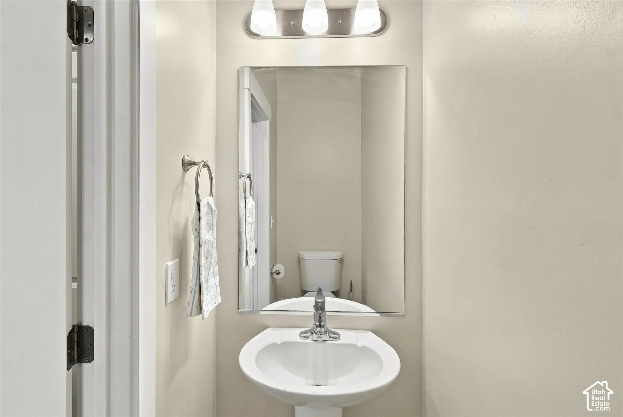 Main floor half bath with pedestal sink.