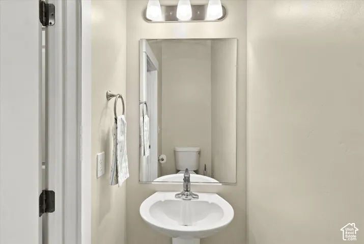 Main floor half bath with pedestal sink.