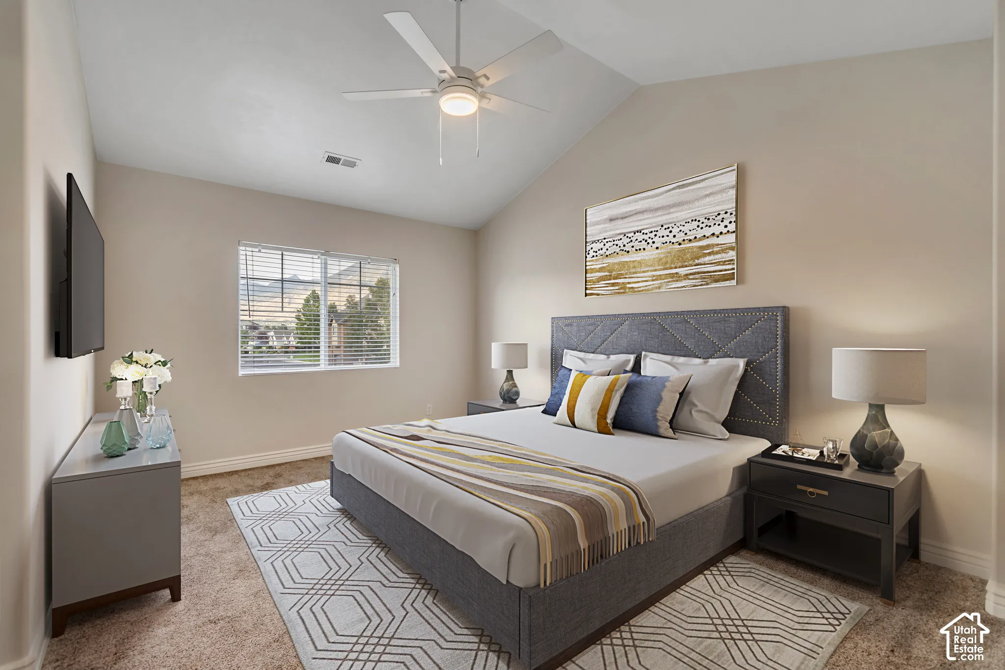 Vaulted ceiling featuring a central lighted ceiling fan, neutral wall tones, and horizontal window blinds