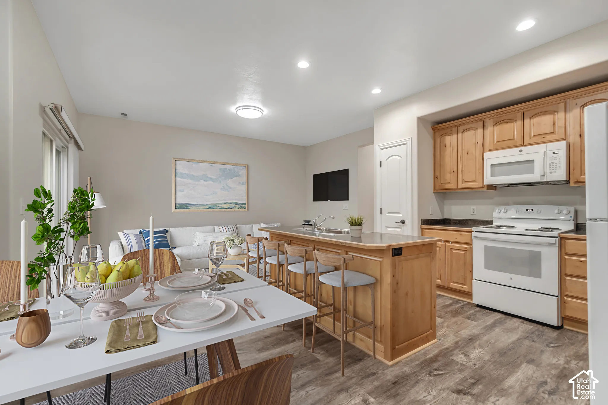 Kitchen featuring natural wood cabinetry, solid-surface countertops, wood-finish flooring, and recessed ceiling lighting
