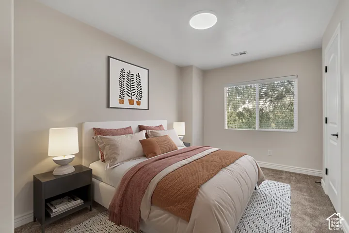 Neutral-toned interior space featuring neutral wall paint, wall-to-wall carpeting, a multi-pane horizontal sliding window, and a modern circular flush-mount ceiling light fixture