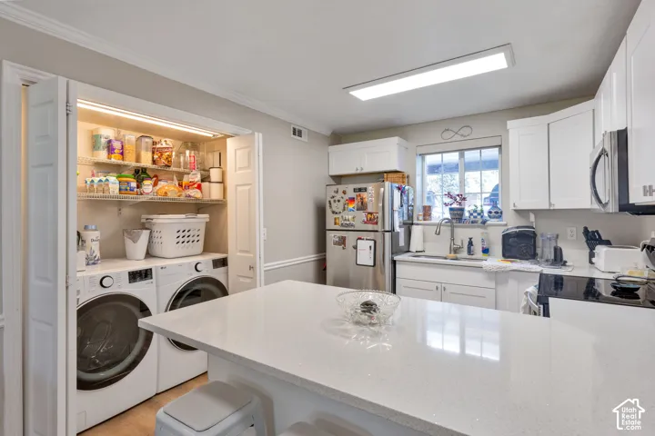 Updated kitchen with new cabinets and counter tops. In closet laundry.