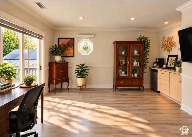 Wood-finish flooring, custom built-in cabinetry with stone-finish countertops, recessed lighting, crown molding, and an octagonal accent window