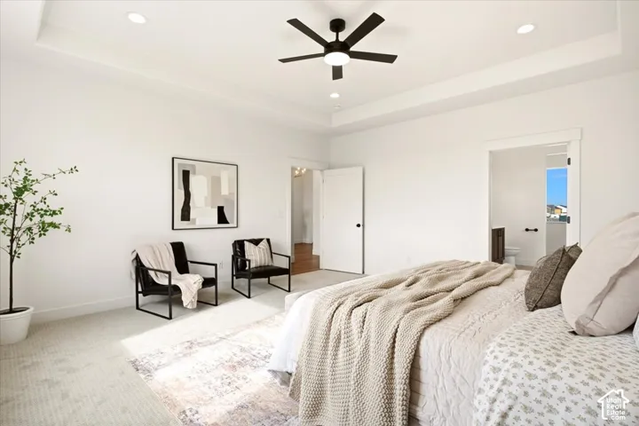 Tray ceiling with recessed lighting and a matte black integrated ceiling fan