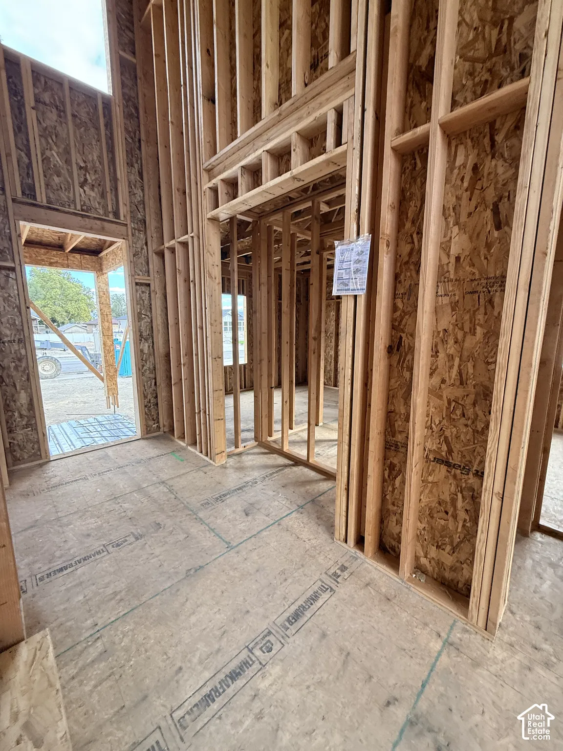 New construction featuring vertical timber framing, high ceilings, oriented strand board structural panels, and open-plan architectural rough-ins