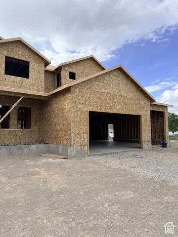 New construction featuring an oriented strand board exterior, multi-gabled roofline, concrete foundation, and an attached multi-car garage