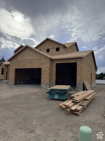 New construction featuring an oriented strand board exterior, multi-gabled roofline, and two-bay garage entry