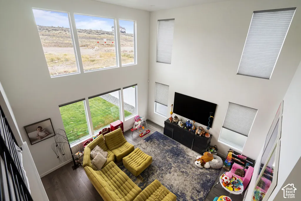 Double-height ceiling, large multi-pane windows, and wood-finish flooring