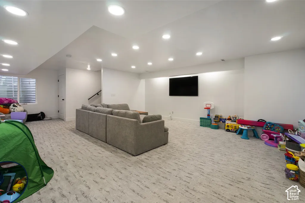 Finished interior space featuring recessed ceiling lighting, patterned wall-to-wall carpeting, and a recessed wall niche with integrated backlighting