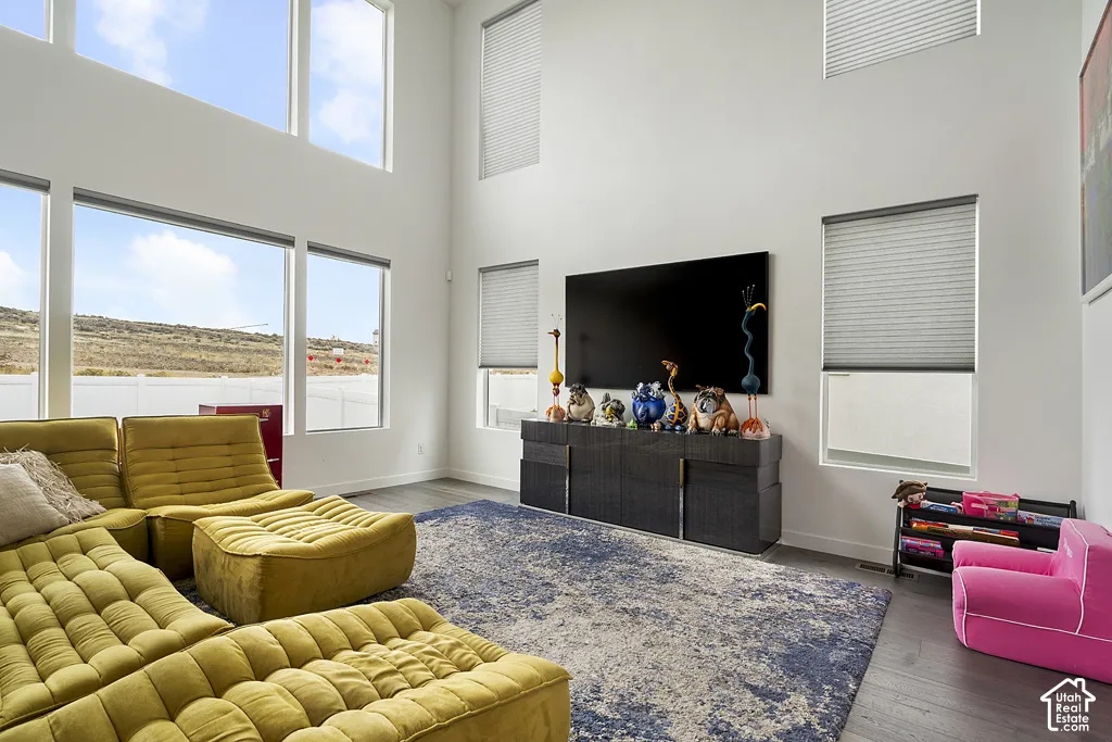 Double-height ceilings featuring floor-to-ceiling windows and wood-finish flooring