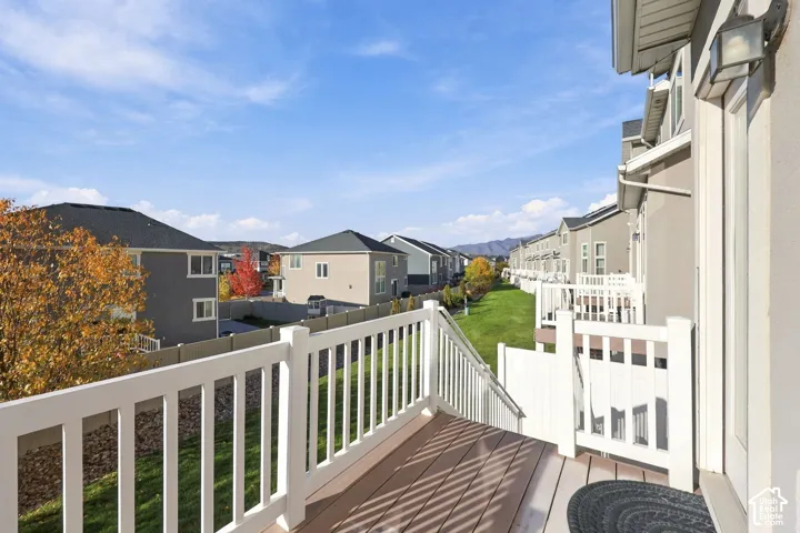 Elevated deck featuring white composite railings and neutral wood-finish decking