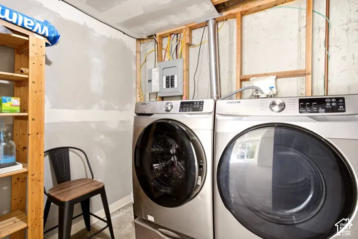 Stainless steel front-load washing machine and dryer set with integrated electrical service panel