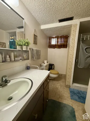 Bathroom featuring an integrated oval sink, built-in vanity cabinetry with drawer storage, and a separate stall shower