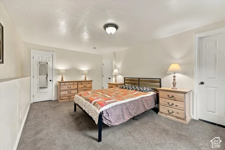 Neutral wall finishes, neutral carpeting, two six-panel interior doors, and a central dome-style ceiling light fixture