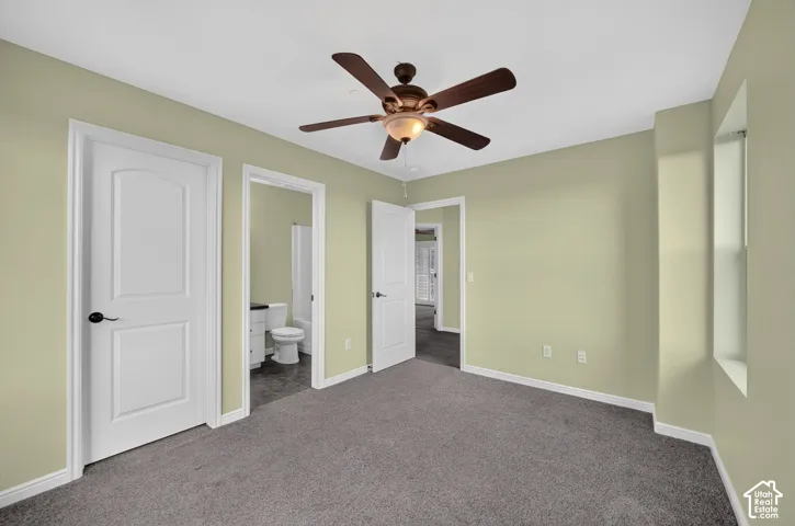 Room featuring neutral wall paint, carpeted flooring, a ceiling fan with integrated lighting, and white paneled doors