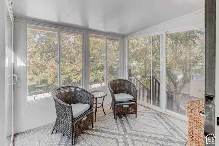 Enclosed sunroom featuring expansive windows and sliding glass doors