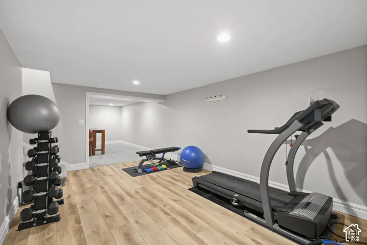 Interior space featuring wood-finish flooring, neutral wall tones, and recessed lighting