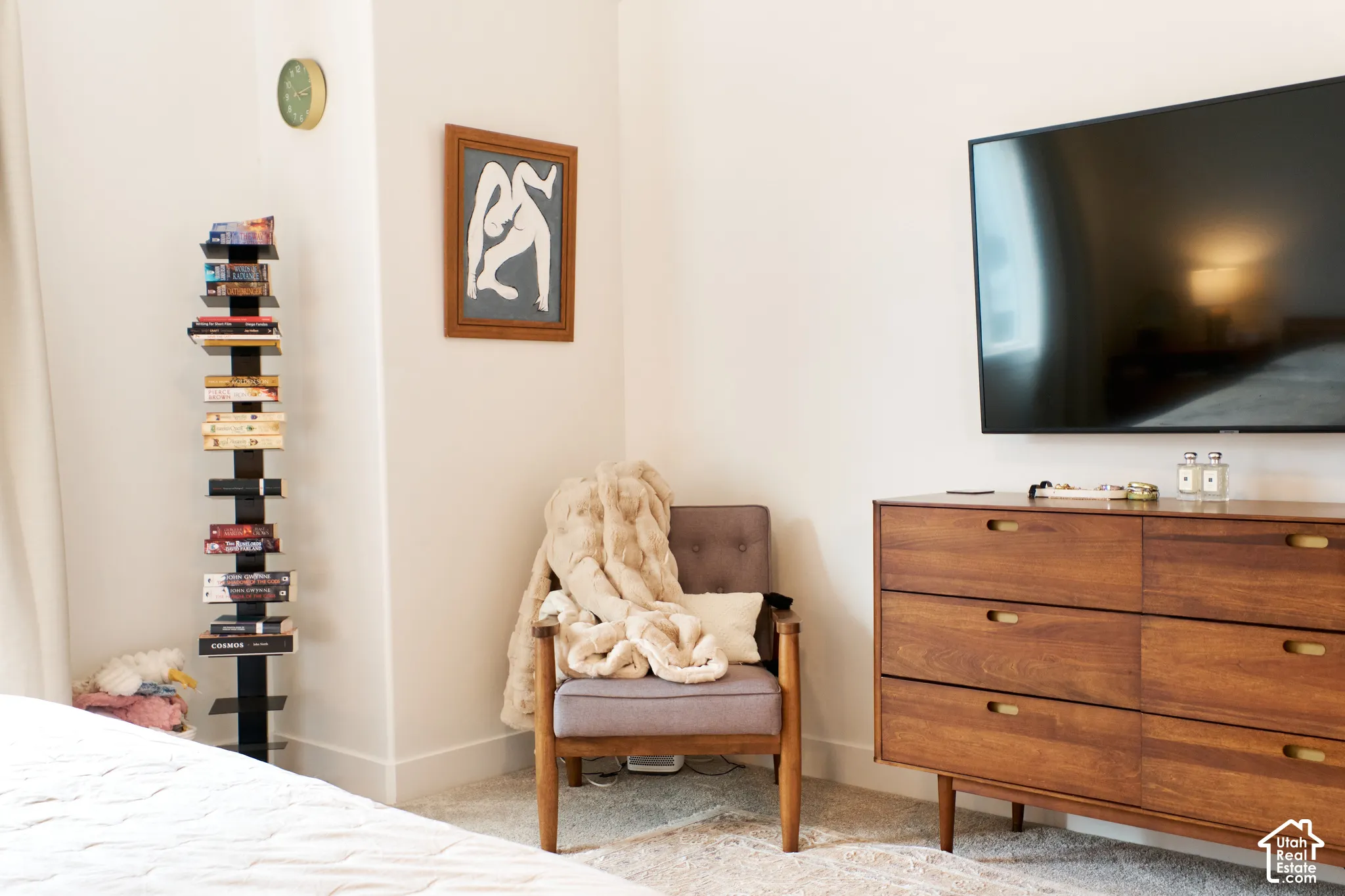 Neutral-toned interior featuring wall-to-wall carpeting and a wall-mounted television