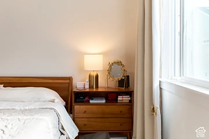 Neutral-toned wall finish and large window with side-panel drapery